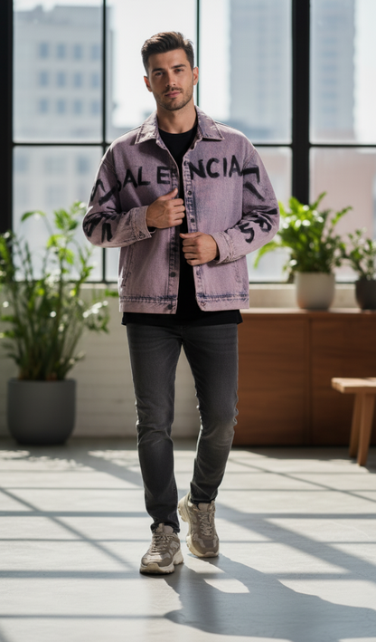 Man wearing a purple jacket with 'Valencia' text in an indoor setting with plants and large windows.
